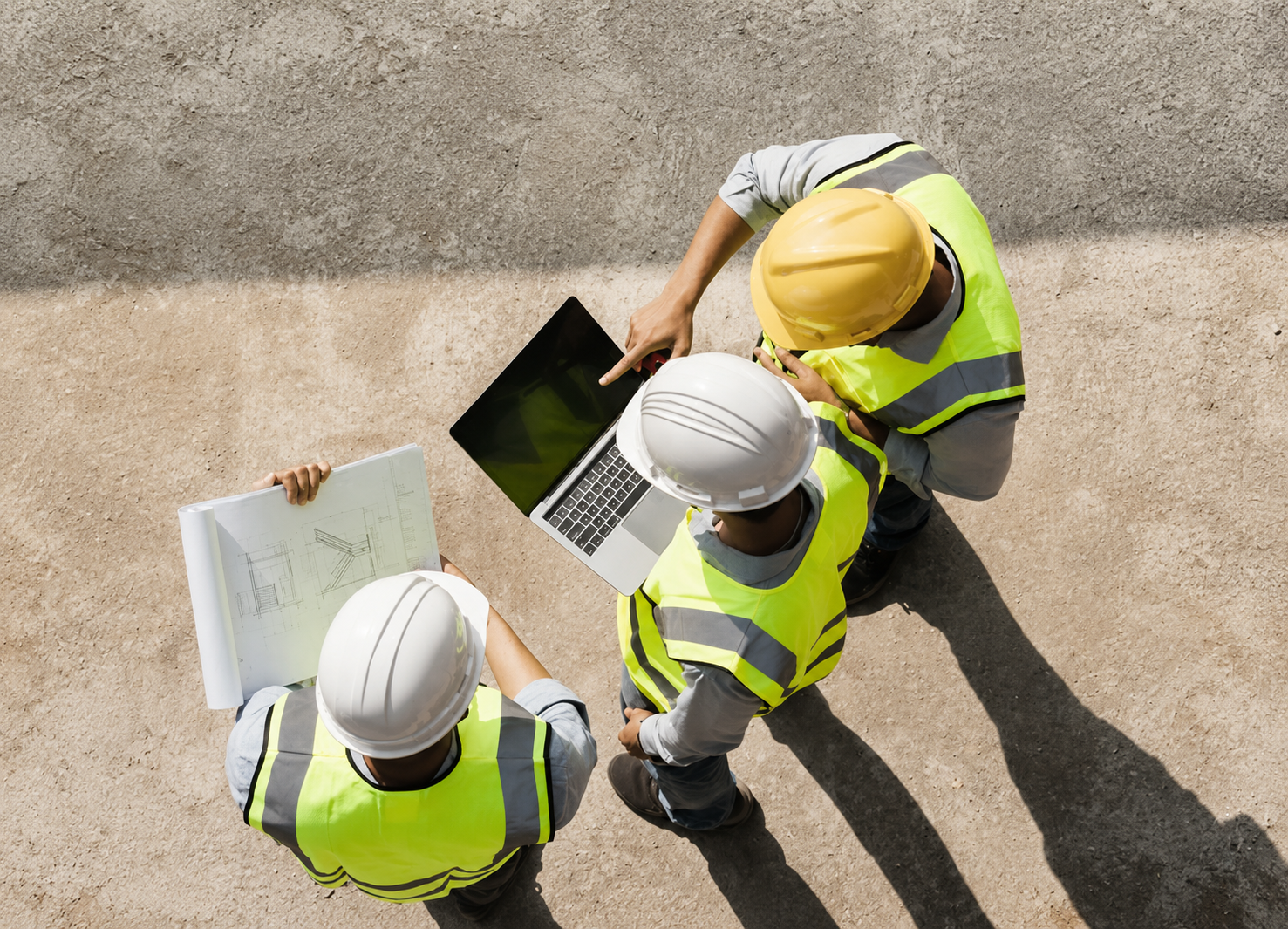 Construction professional using project tracking software on a laptop